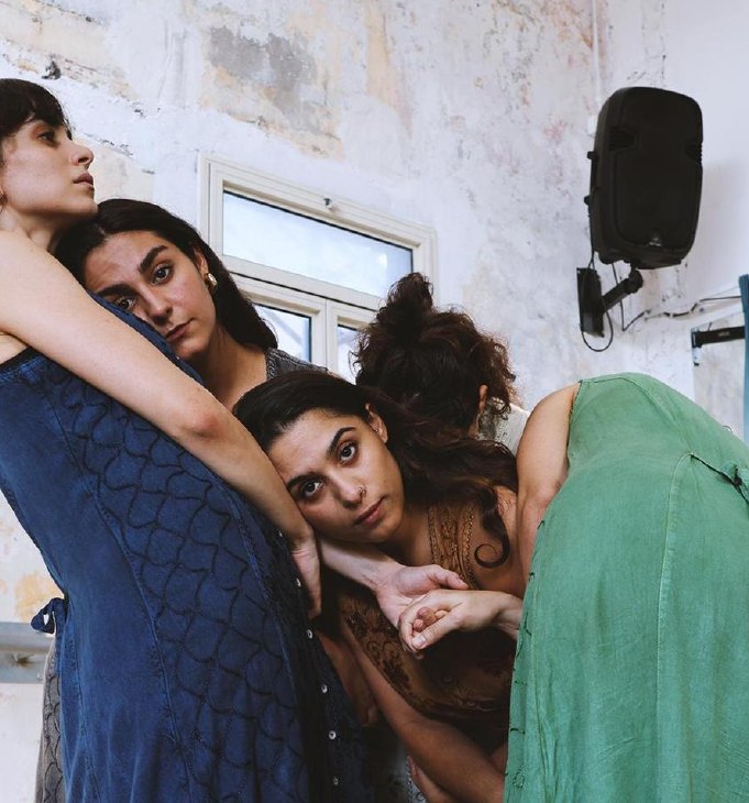 Four dancers leaning into one another, Arabesque