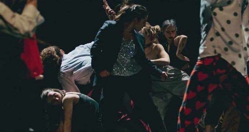 Ensemble in a dark, crowded stage scene, Parallel Stories