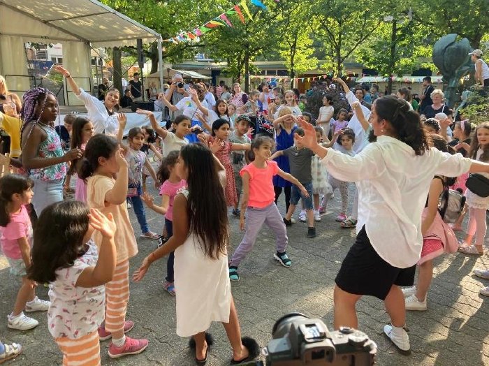 Children dancing along at an outdoor festival
